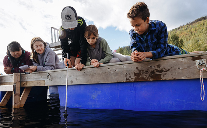kids testing water off a dock