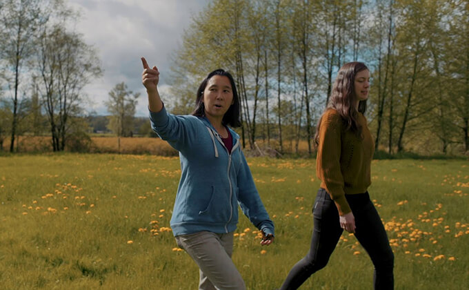 women walking through field